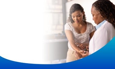 Woman showing her arm with eczema to her doctor